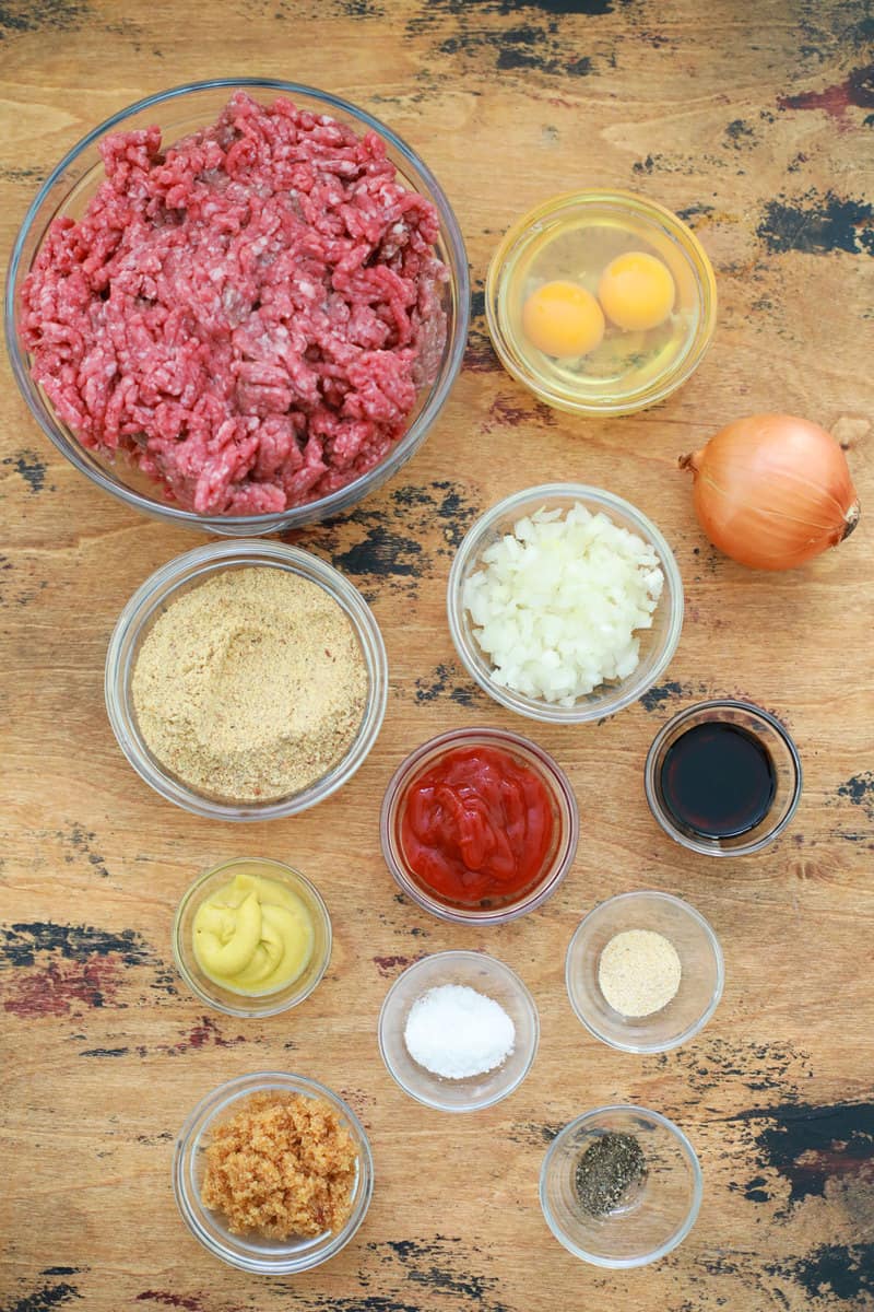 ingredients for meatloaf in glass bowls on wooden table