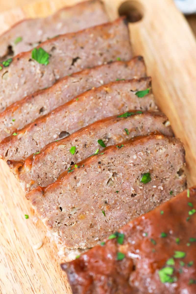 closeup of sliced meatloaf on cutting board