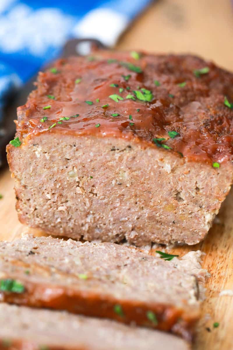 Meatloaf sliced on wooden cutting board