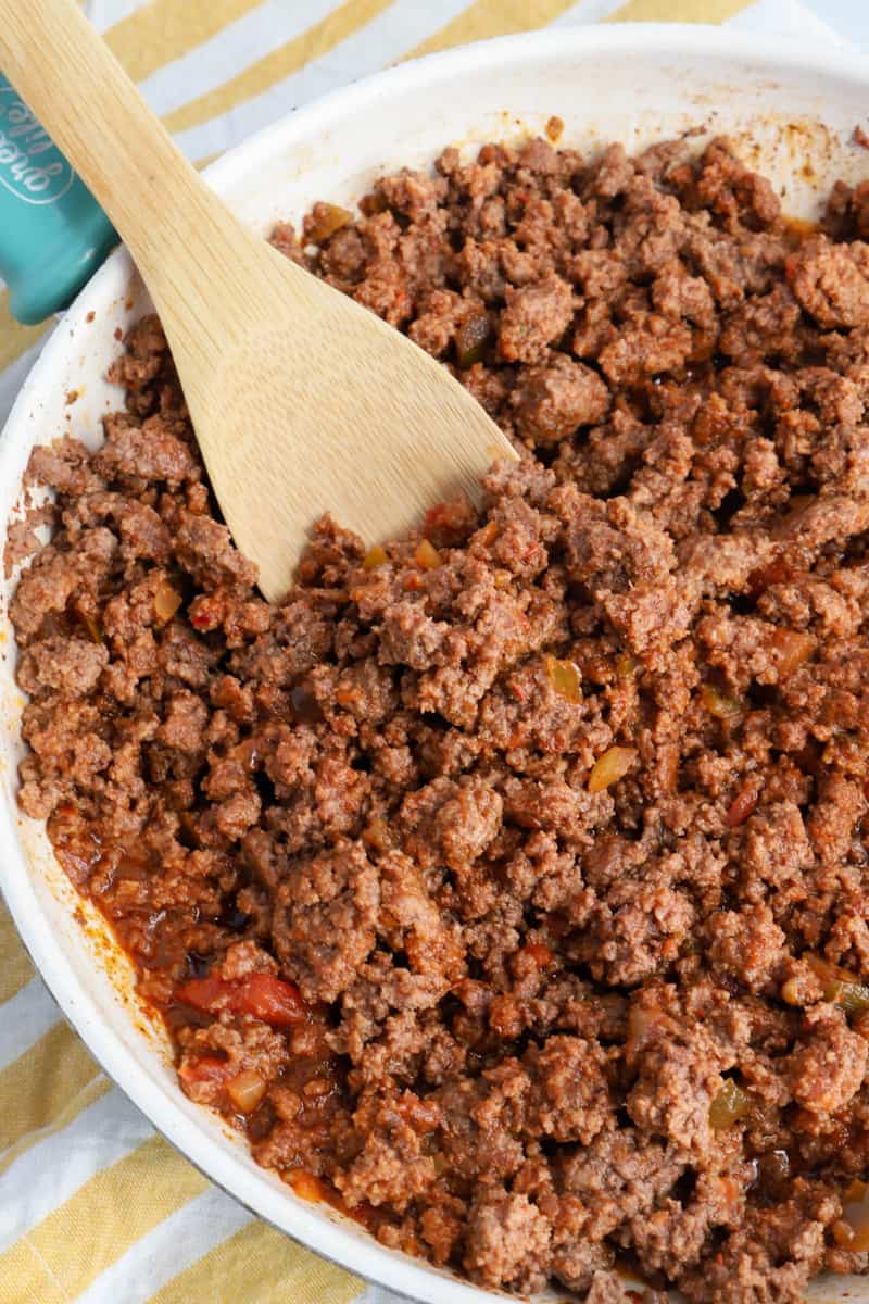 closed up of cooked ground beef mixed with salsa and seasoning in skillet