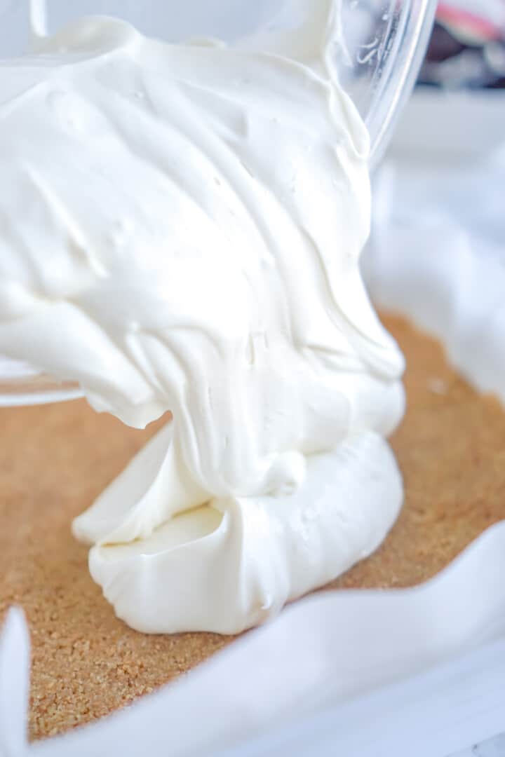 pouring cheesecake into the crust