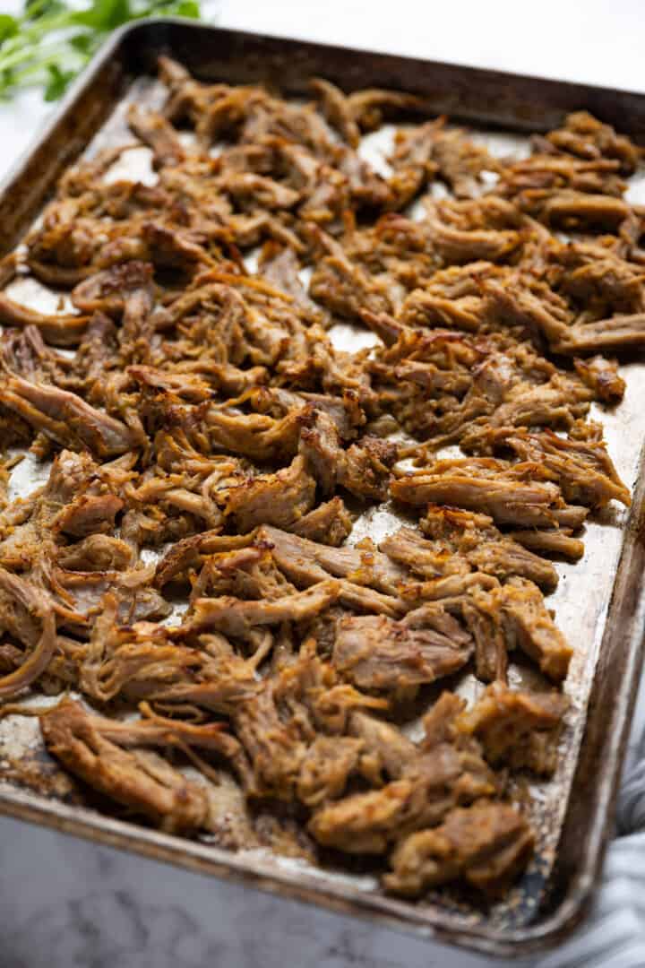 pork carnitas on a baking sheet about to be broiled