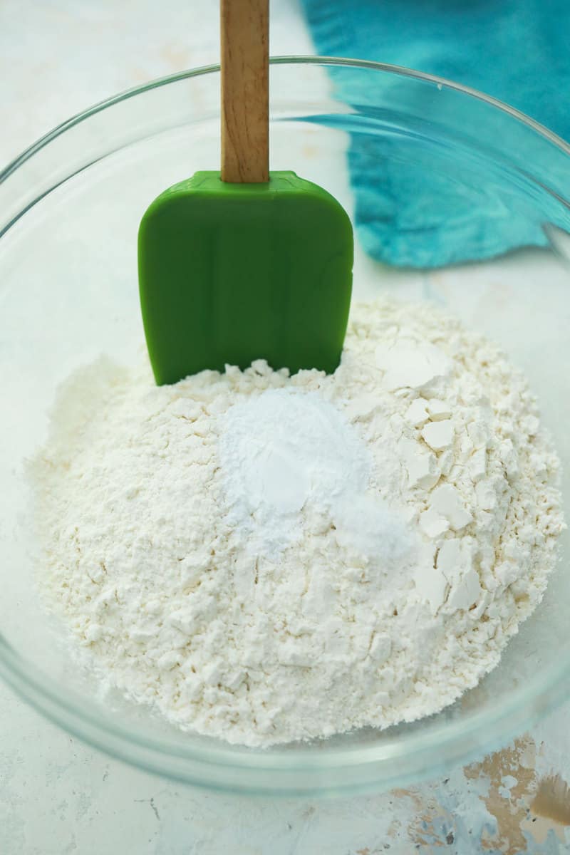 mixing together flour salt and baking powder in glass bowl