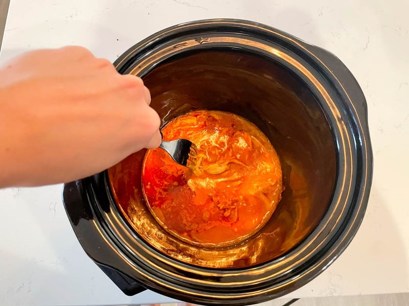 shredding the chicken in the slow cooker