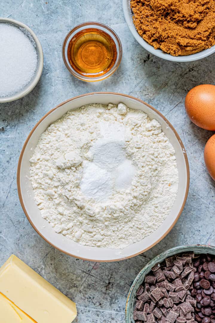 close up of ingredients with salt, baking powder and soda added to flour.