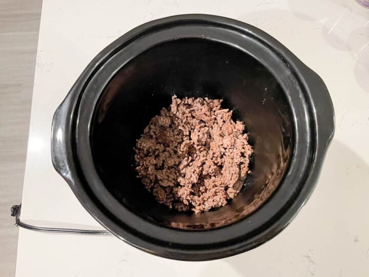 ground beef in the bottom of the slow cooker.
