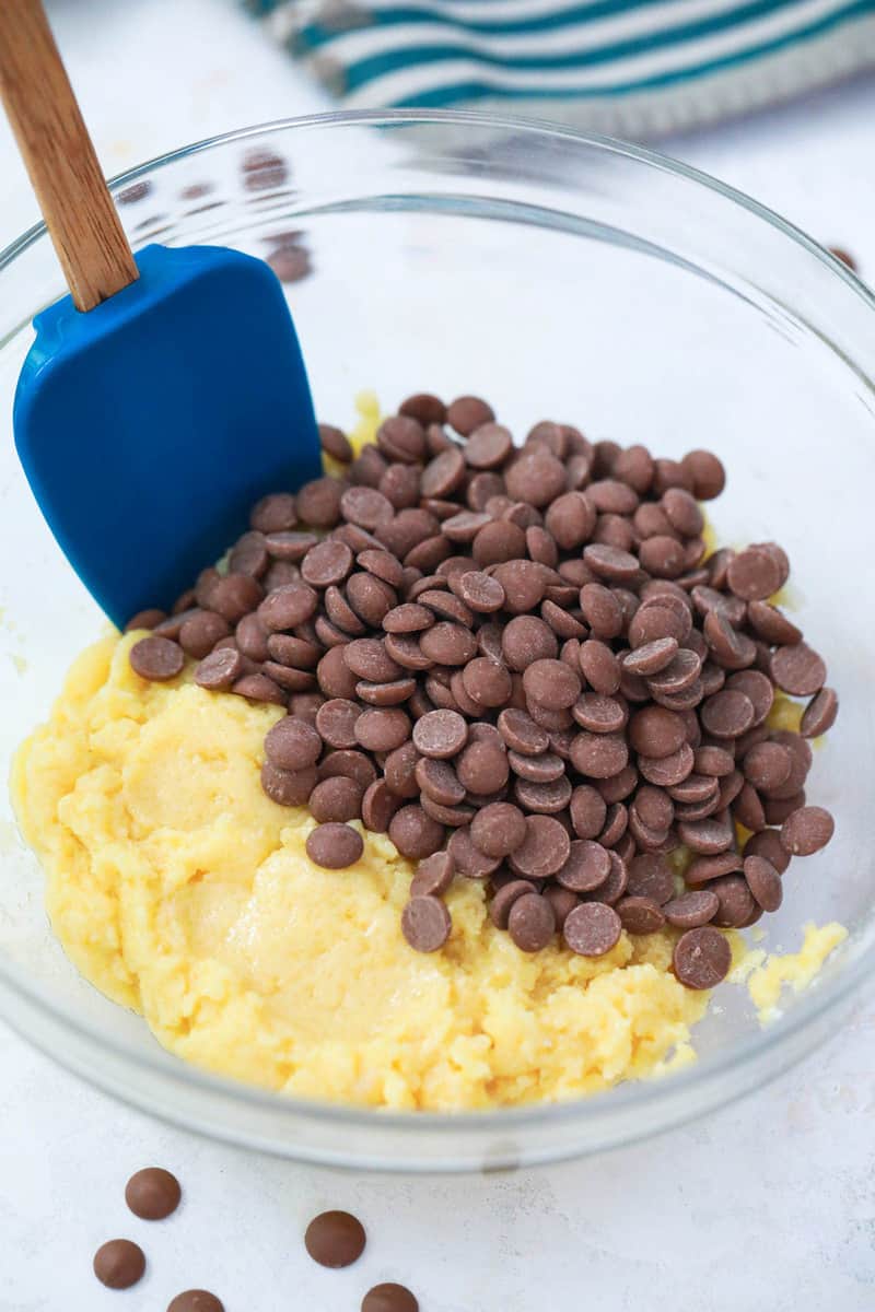 adding chocolate chips to the dough