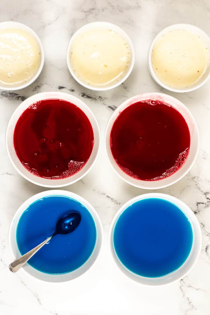 white bowls filled with the red white and blue Jello mixes