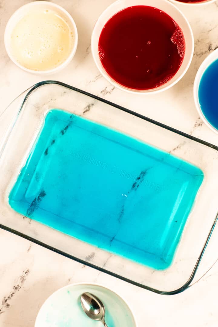 adding the blue Jello mix to the baking dish