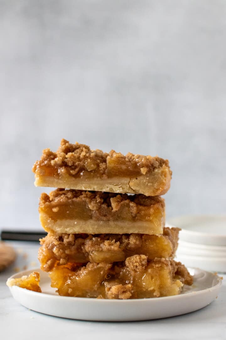 Dutch Apple Pie Bars on white plate stacked