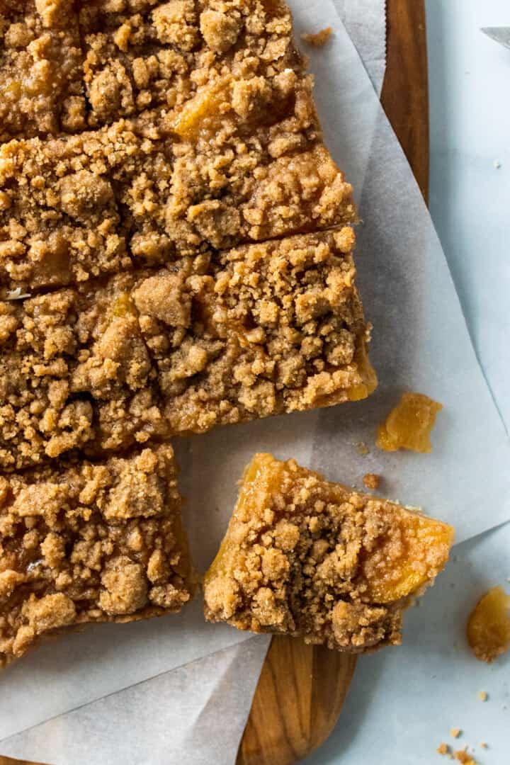 Dutch apple pie bars sliced and cut into squares on a cutting board
