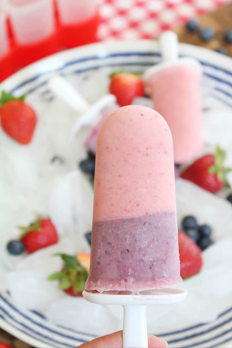 close up of a blueberry and strawberry layered popsicle.