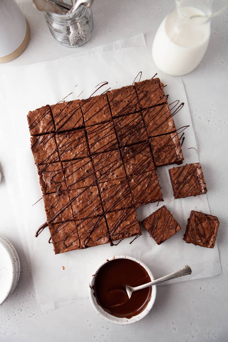 brownies sliced on parchment paper into squares.