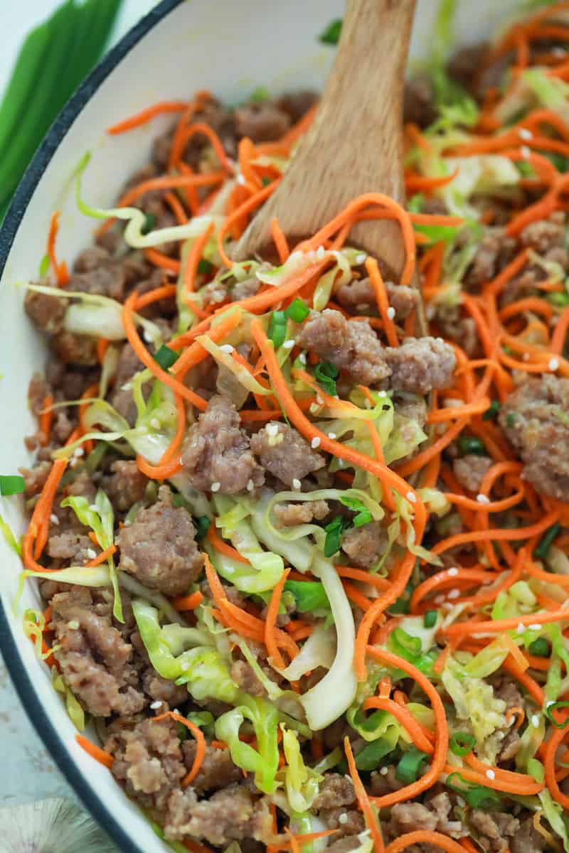 egg roll in a bowl on wooden spoon.