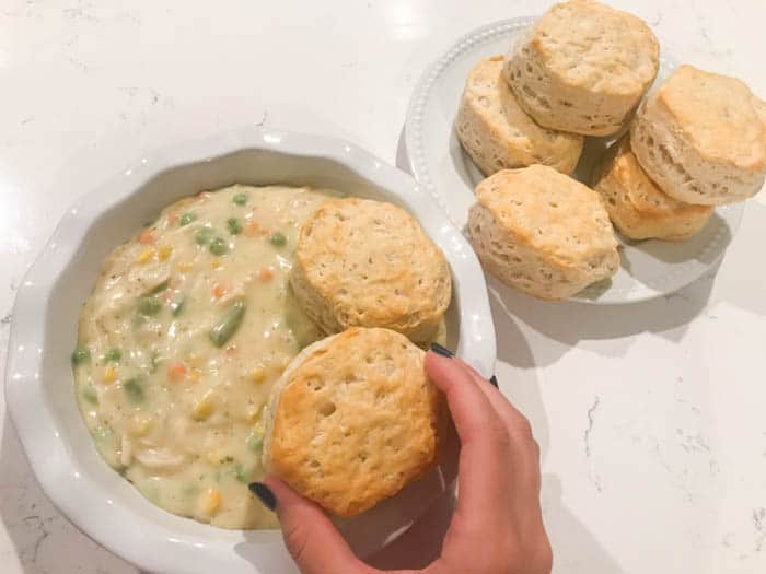 adding biscuits to the casserole dish