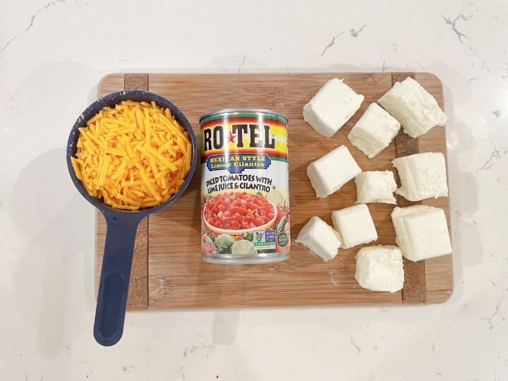 ingredients for cheeseburger dip on wooden cutting board