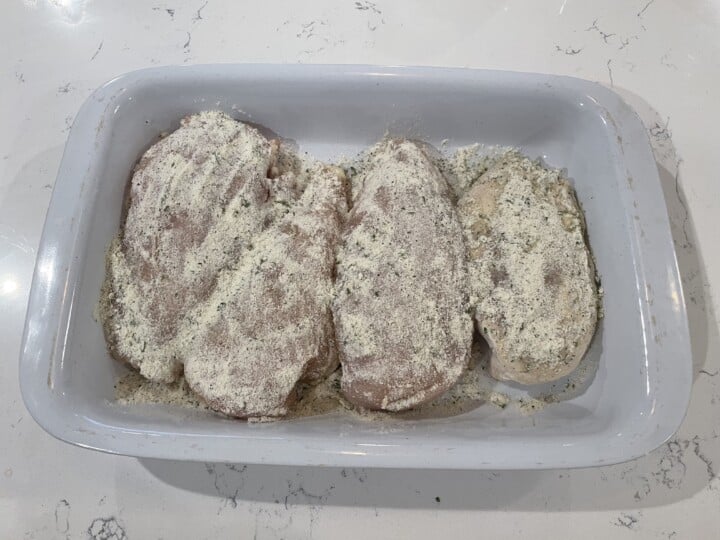 chicken breasts rubbed with ranch seasoning in casserole dish