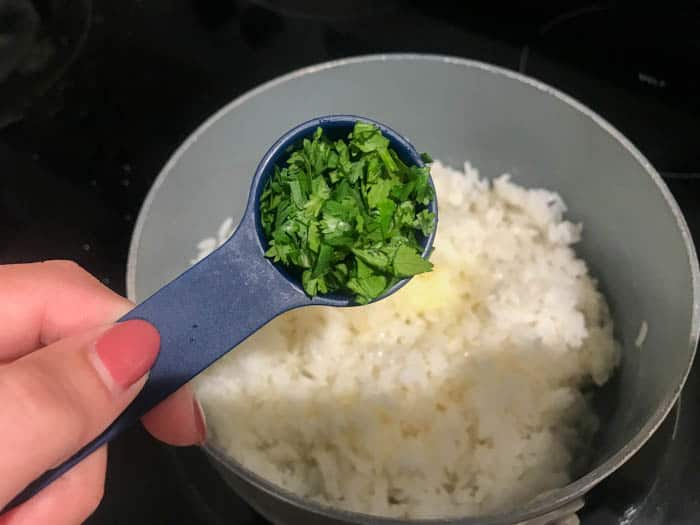 adding cilantro to the rice