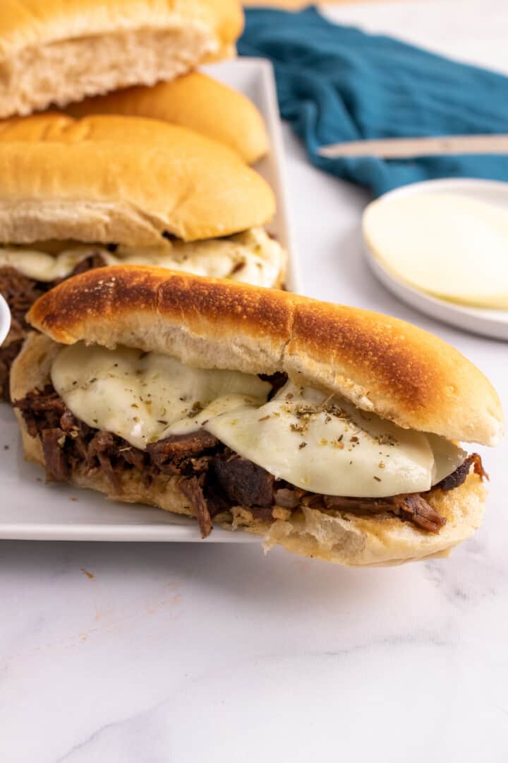 Slow Cooker French Dip sandwiches on a white serving plate.