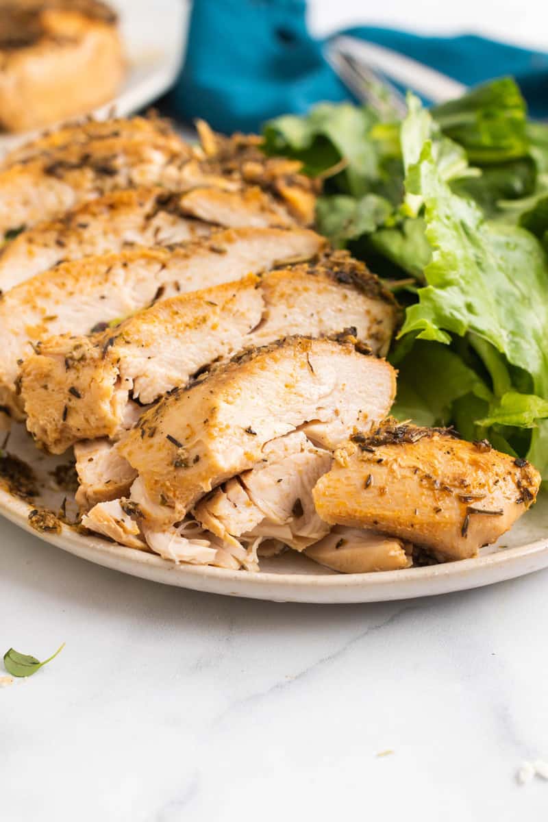 Close up picture of slow cooker turkey breast sliced on a plate