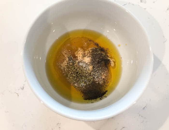 oil honey and seasoning mixed in a small bowl