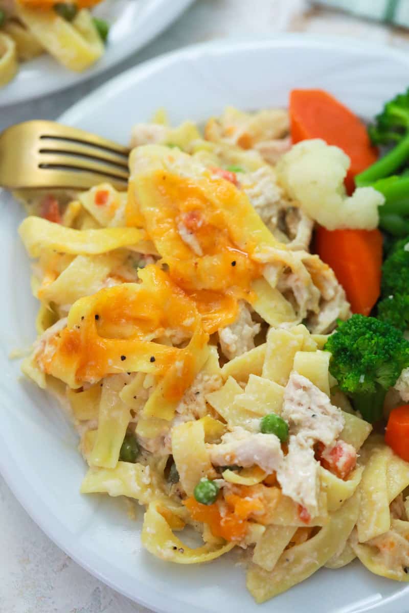 Chicken Noodle Casserole on a plate with vegetables