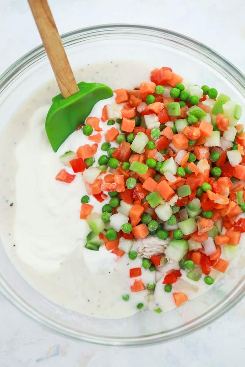 mixing the cream of chicken soup with the vegetables