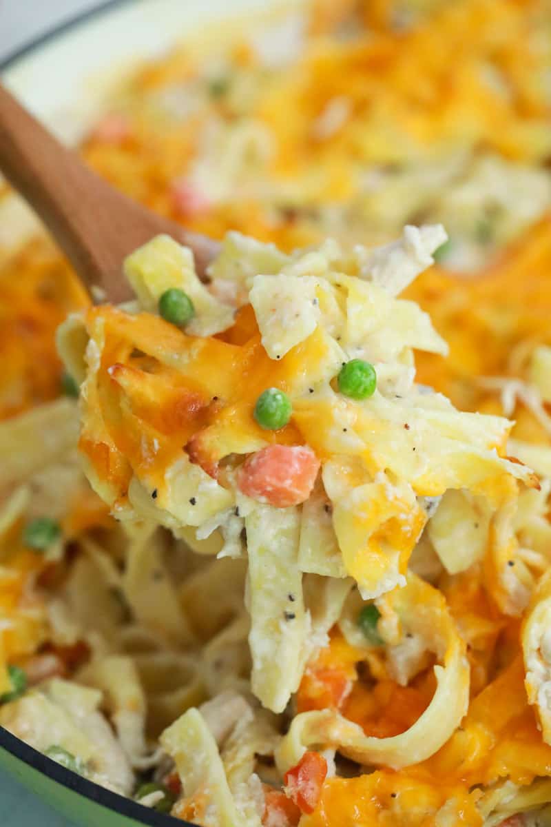 Chicken Noodle Casserole being scooped out with wooden spoon