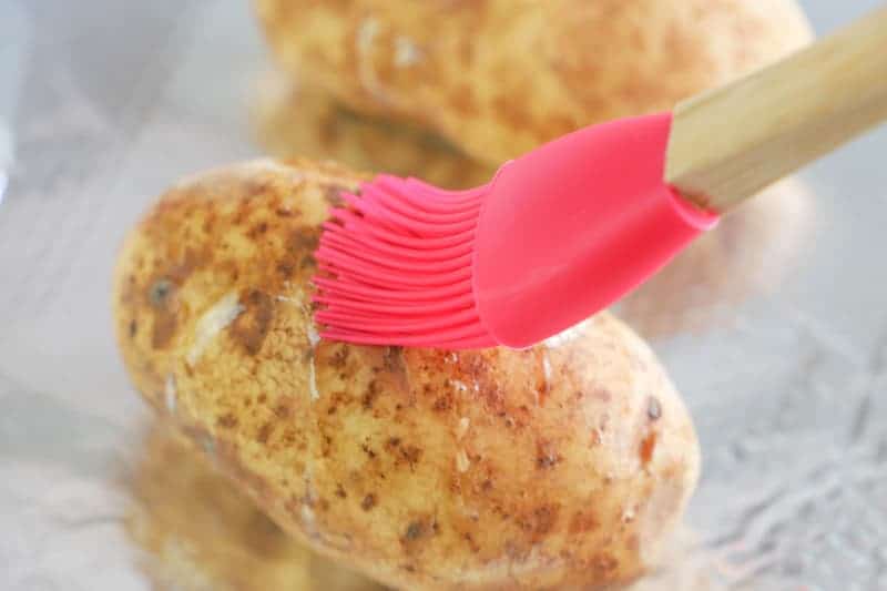 brushing potatoes with oil
