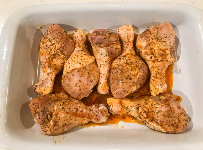 placing chicken in baking pan