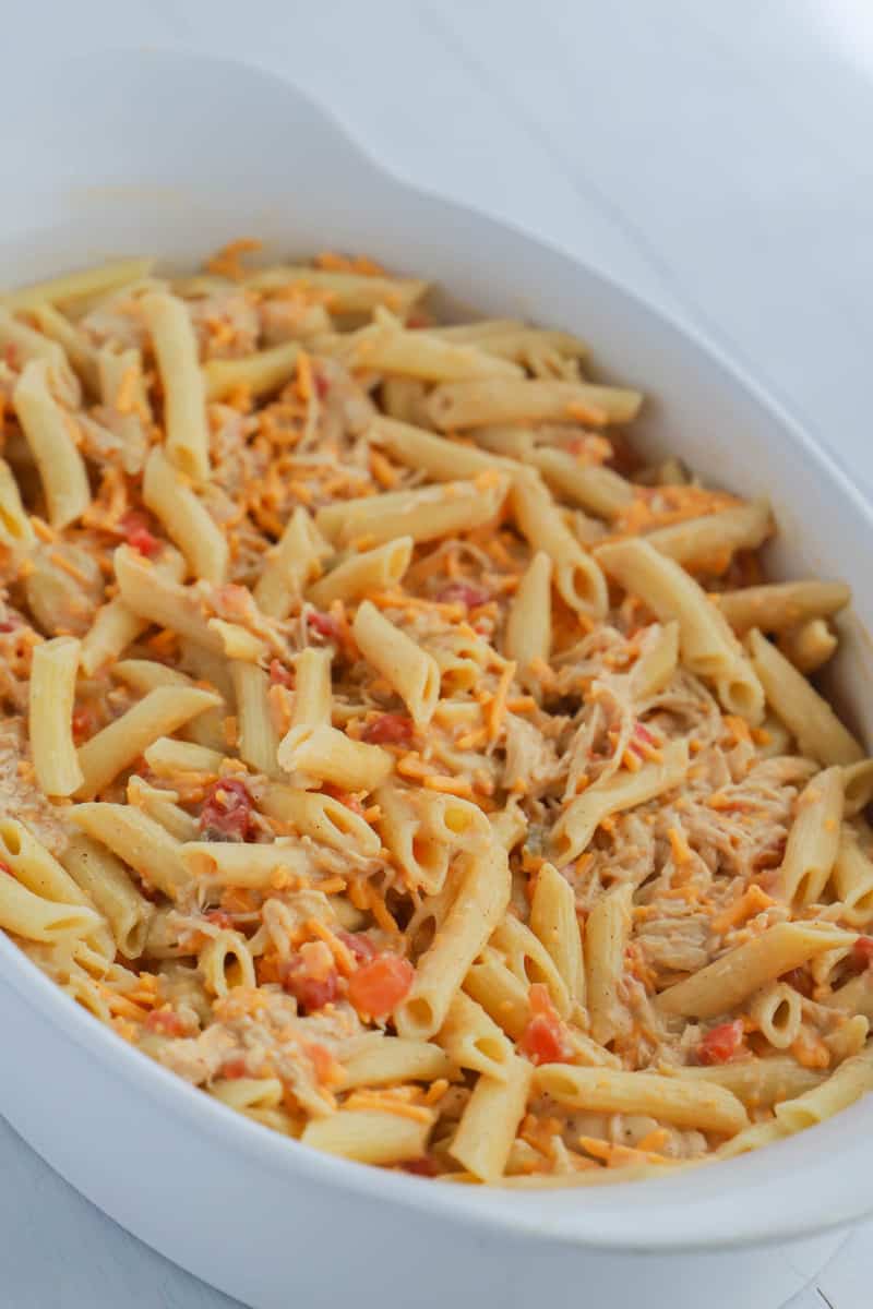 cheesy chicken casserole all mixed in casserole dish before baking