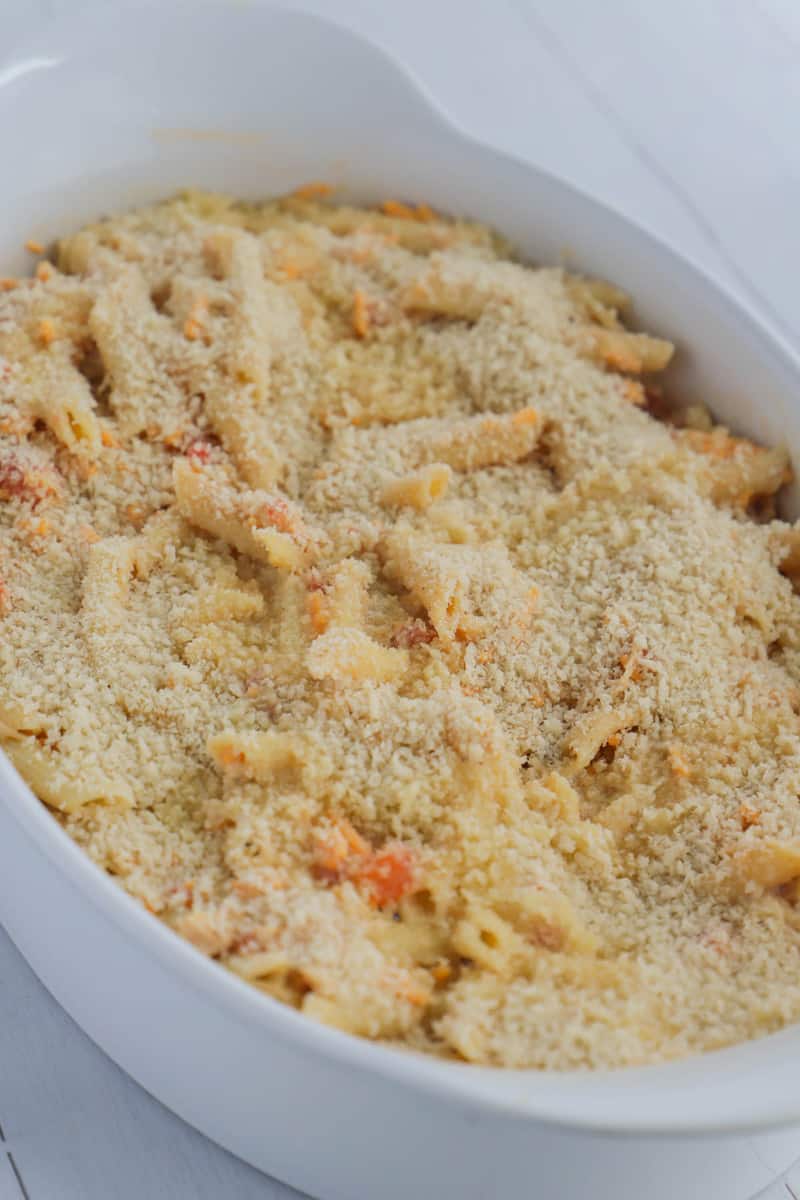 cheesy chicken casserole topped with panko in casserole dish before baking