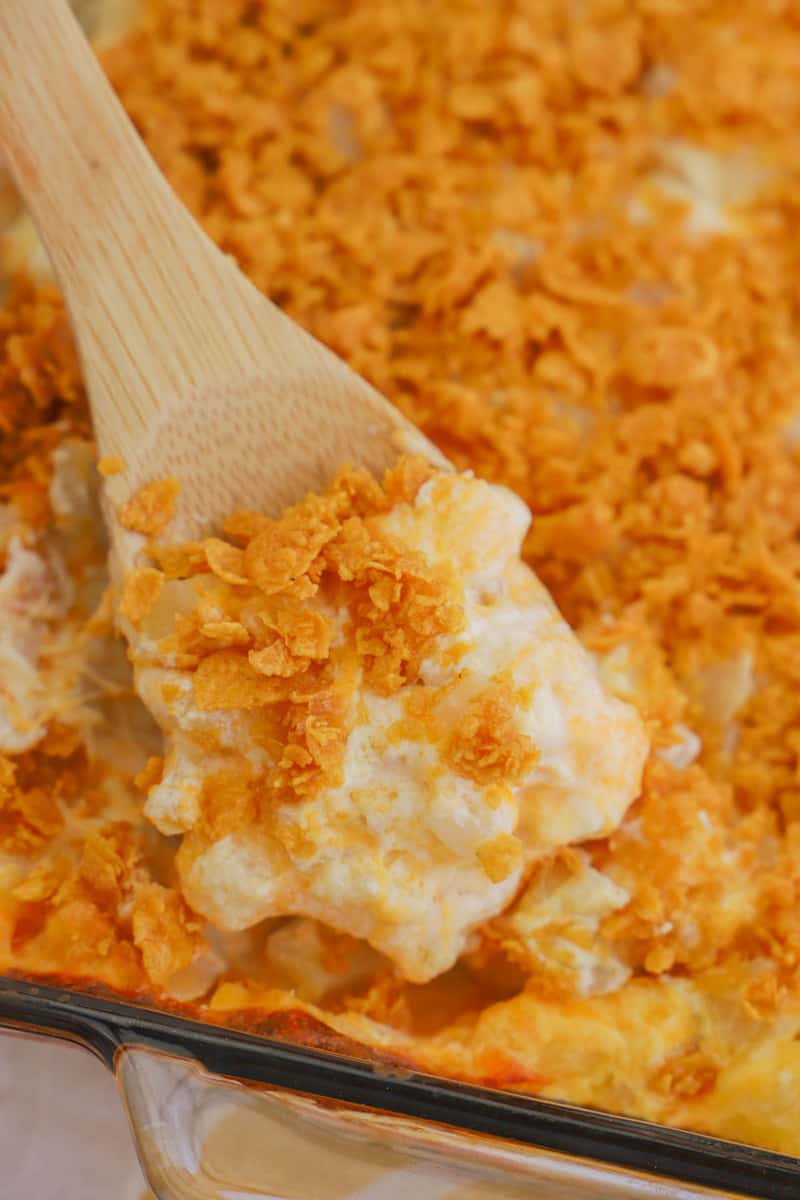 closeup of funeral potatoes on a wooden spoon