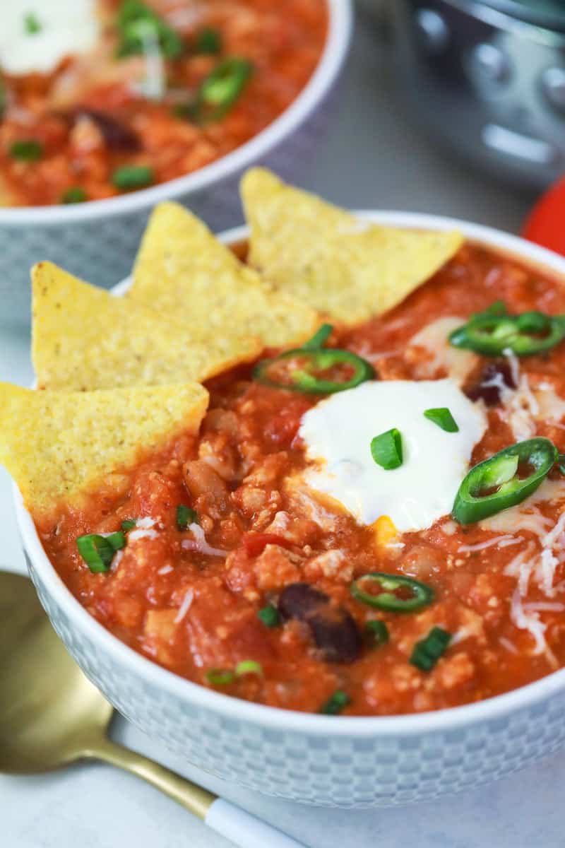 Slow Cooker Turkey Chili in a bowl with tortilla chips.