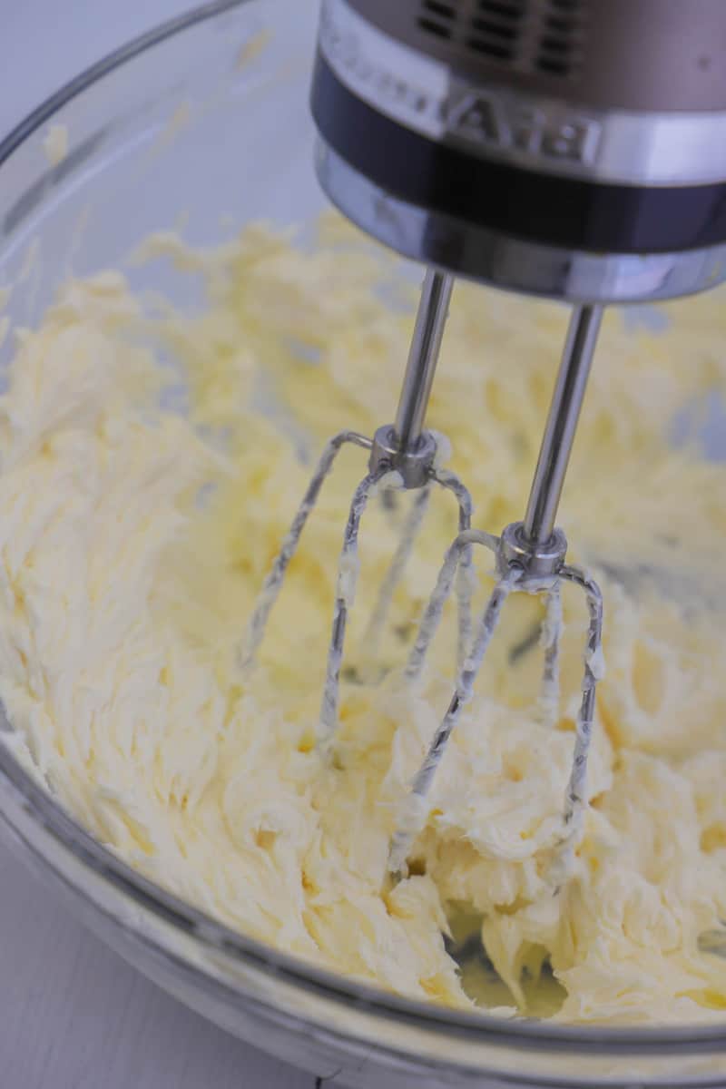 cream cheese frosting being mixed in a stand mixer