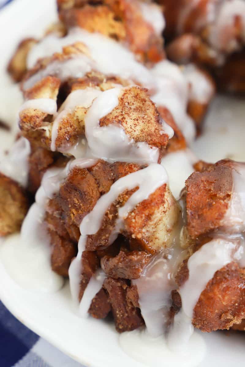 closeup of cinnamon roll monkey bread with icing drizzled on it