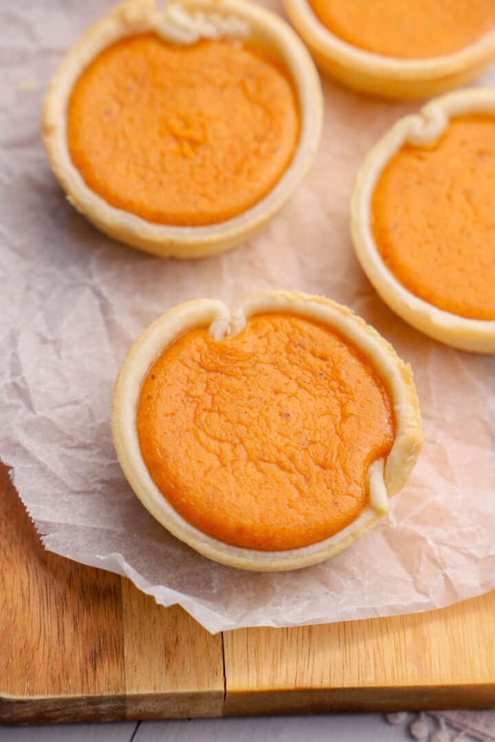 baking mini pumpkin pies on a wooden board