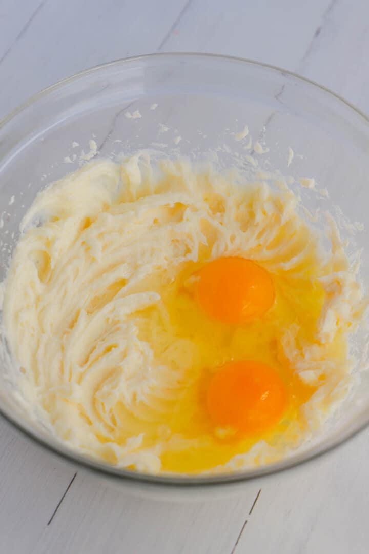 adding eggs in to cream cheese mix