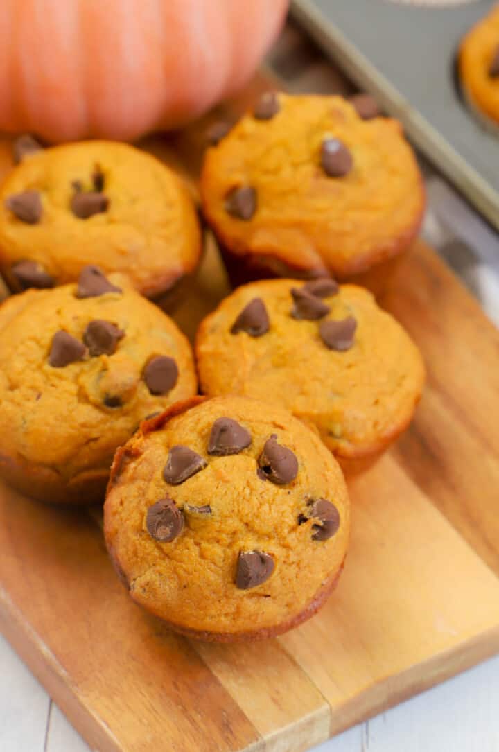 Chocolate Chip Pumpkin Muffins on wooden serving board.