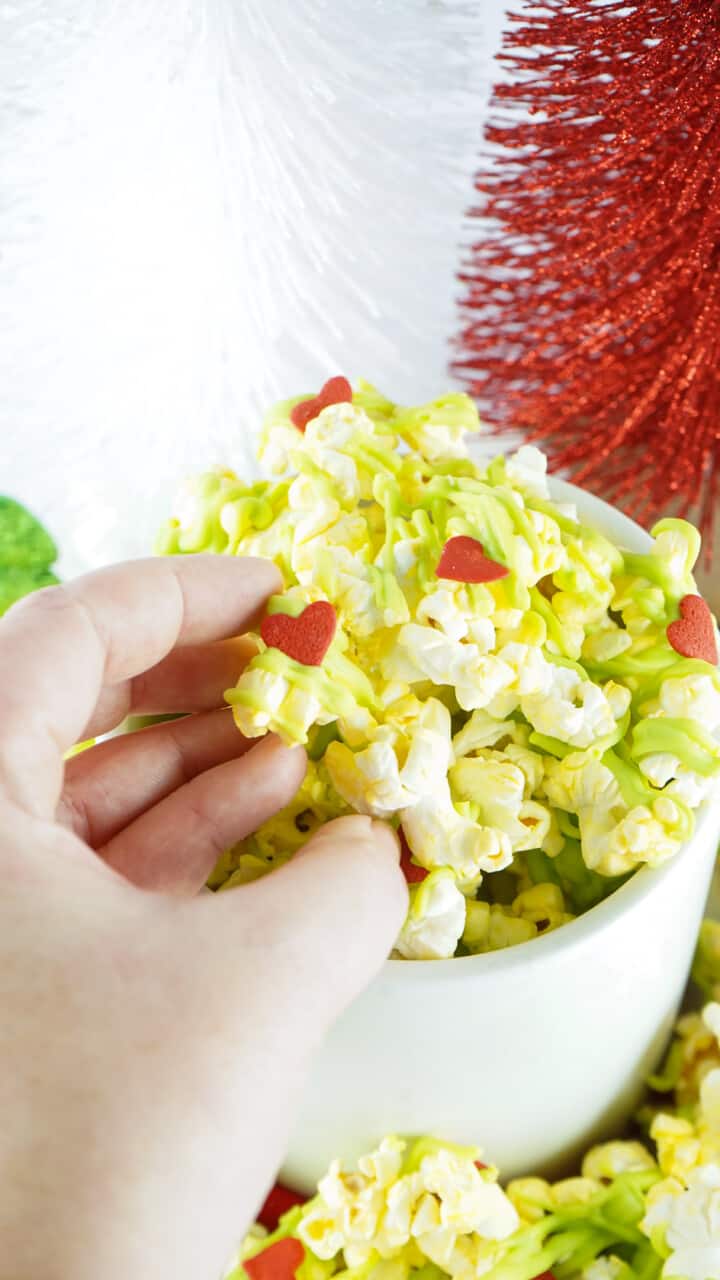 Grinch popcorn in hand closeup