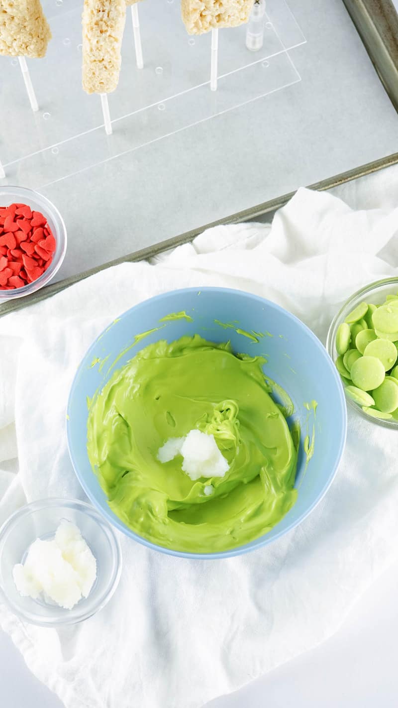 adding coconut oil to the melted candy