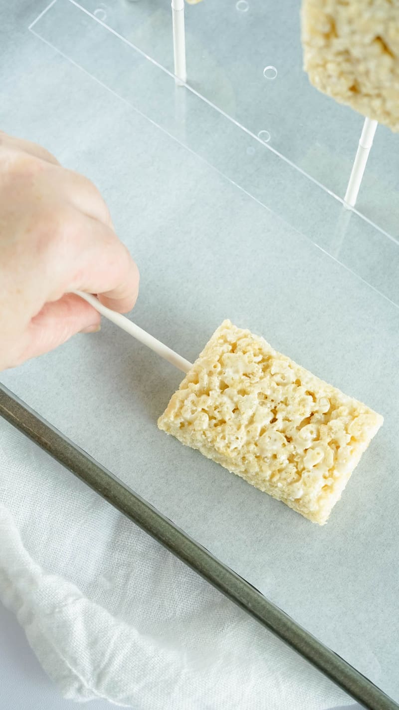 putting the pop sticks into the rice Krispie treat