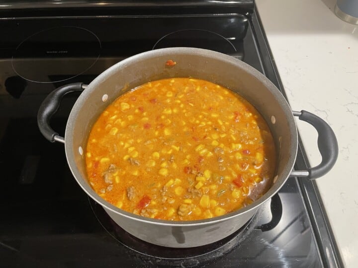 simmering beef nacho soup on stovetop