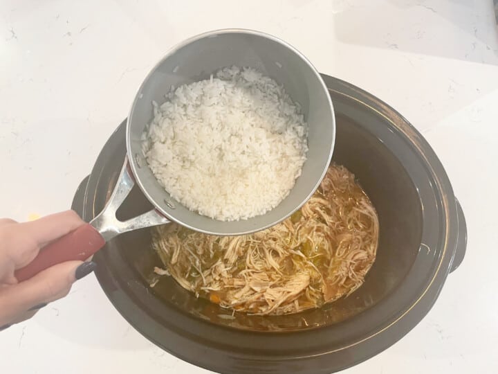 adding cooked rice to the slow cooker