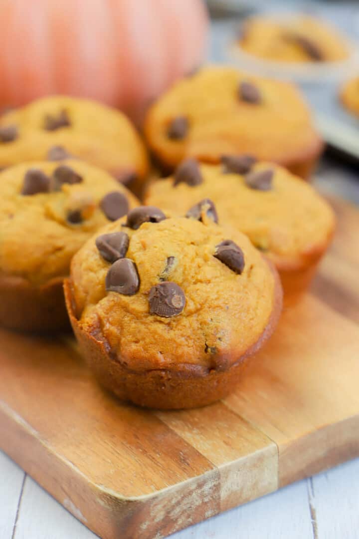 Chocolate Chip Pumpkin Muffins on wooden serving board.