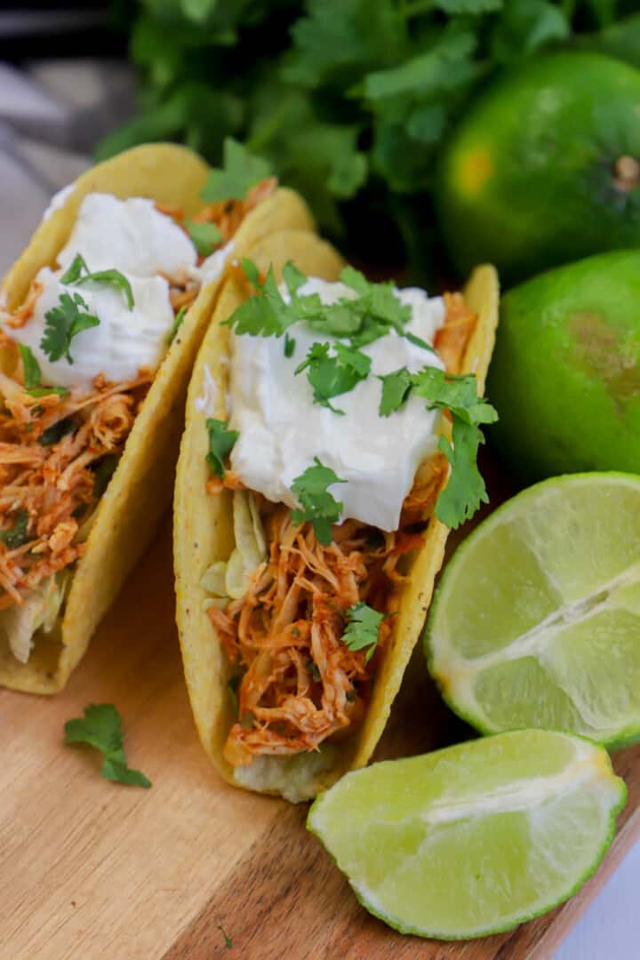 cilantro lime chicken tacos close up on wooden board