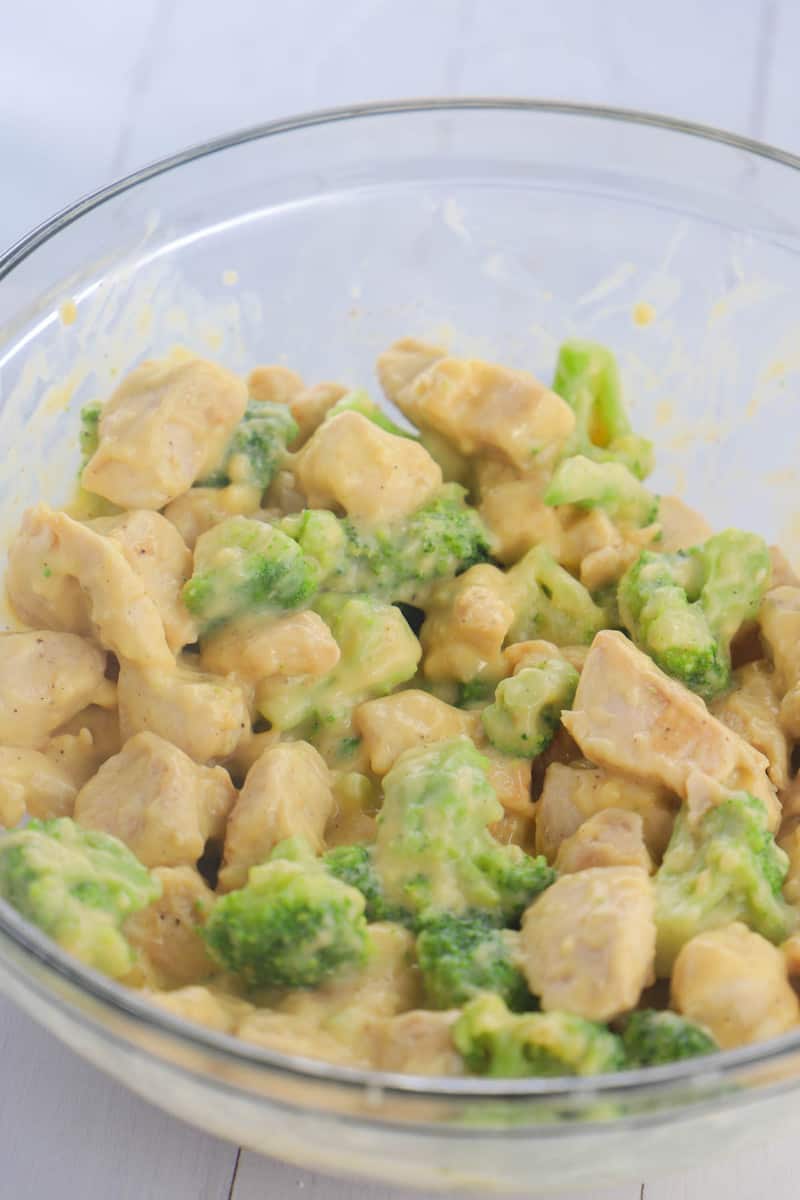 mixing casserole ingredients together in a glass bowl