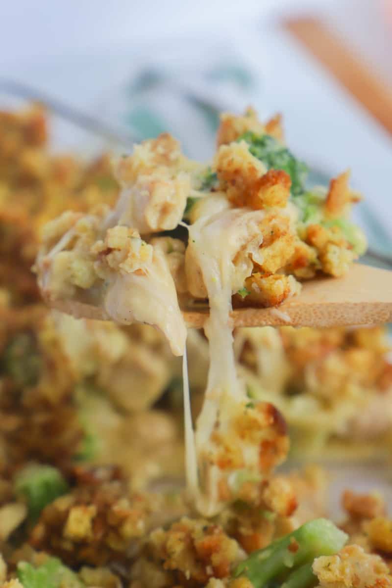 close up of chicken stuffing casserole on wooden spoon