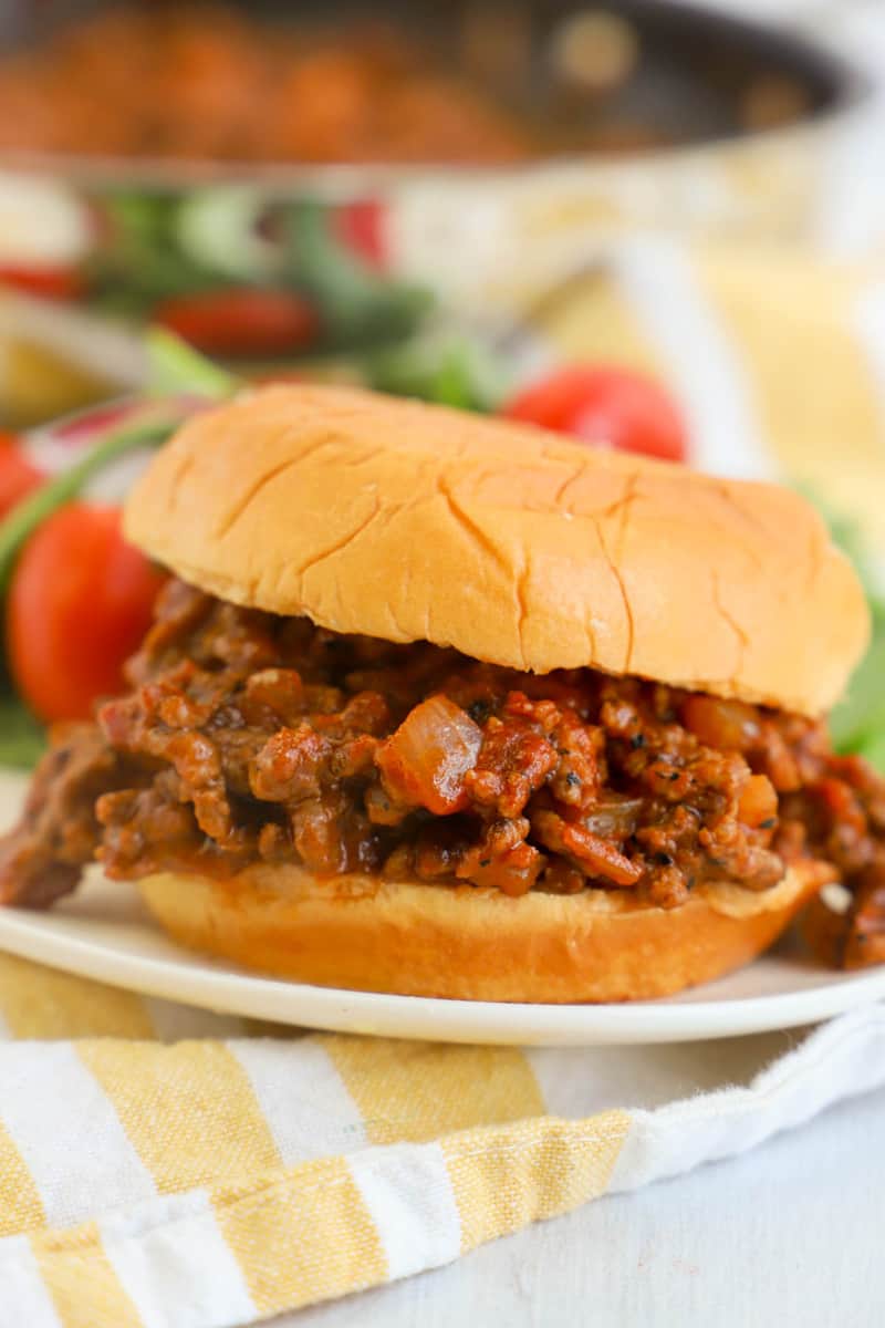 sloppy joe on white plate with salad