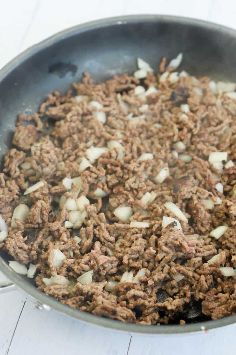 cooking ground beef and onions in a skillet